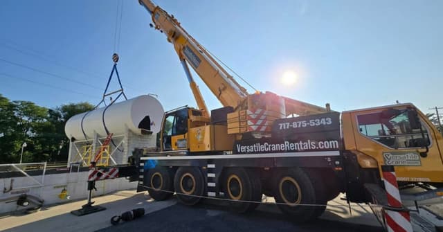 A boom truck working a commercial rooftop lift